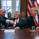 President Donald Trump, right, reaches over Deputy Secretary of State John Sullivan to shake hands with acting Attorney General Matthew Whitaker during a meeting of Trump’s cabinet in the Cabinet Room at the White House February 12, 2019 in Washington, DC. Trump said he was not happy about the compromise legislation agreed to by Republicans and Democrats that would prevent a new partial federal government shutdown but said he would accept the deal.